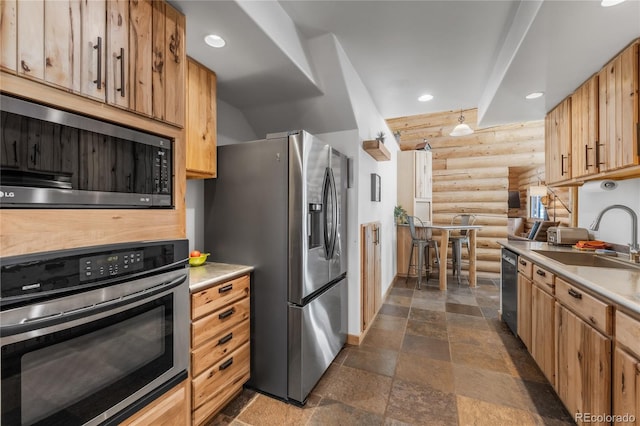 kitchen featuring appliances with stainless steel finishes, sink, and log walls