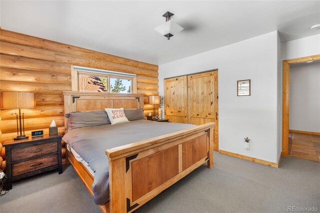 carpeted bedroom with rustic walls