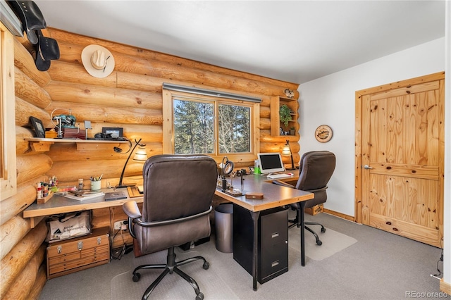 carpeted home office with rustic walls