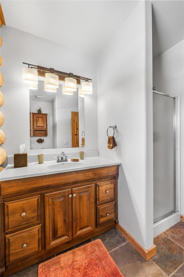 bathroom with a shower with door and vanity