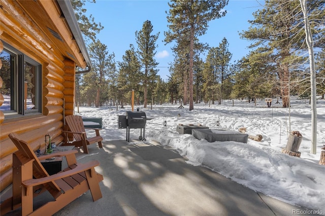 snow covered patio with area for grilling