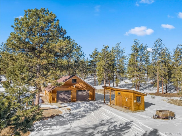 log cabin with an outbuilding and a garage