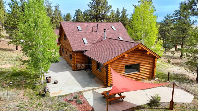 209 Haystack Rd, Hartsel, CO 80449 - back of property featuring log exterior and a patio area