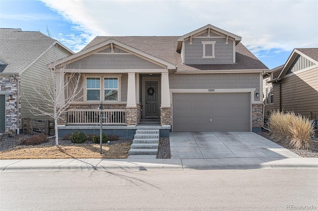 craftsman-style house with driveway, a porch, a shingled roof, a garage, and stone siding