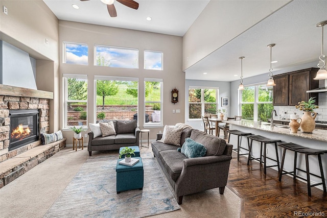 13942 W 87th Dr, Arvada, CO 80005 - living room featuring a ceiling fan, a fireplace, and recessed lighting