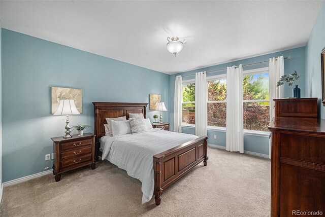 13942 W 87th Dr, Arvada, CO 80005 - bedroom featuring light carpet and baseboards
