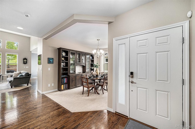 13942 W 87th Dr, Arvada, CO 80005 - entrance foyer with a chandelier, dark wood finished floors, and baseboards