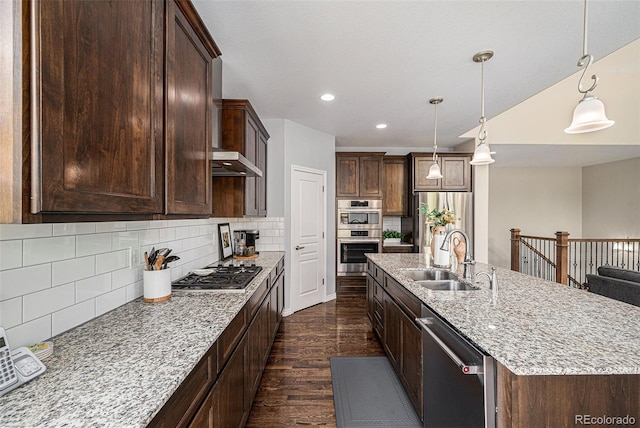 13942 W 87th Dr, Arvada, CO 80005 - kitchen with a sink, appliances with stainless steel finishes, dark wood-type flooring, dark brown cabinets, and decorative backsplash