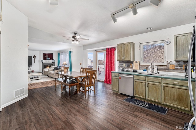 kitchen featuring stainless steel dishwasher, decorative backsplash, dark hardwood / wood-style flooring, ceiling fan, and sink