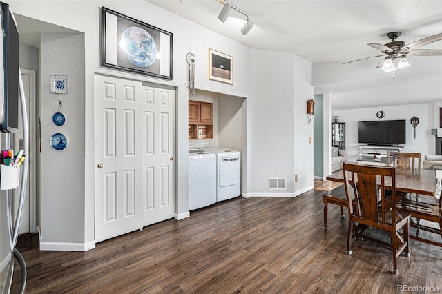 dining space featuring rail lighting, ceiling fan, separate washer and dryer, and dark hardwood / wood-style flooring