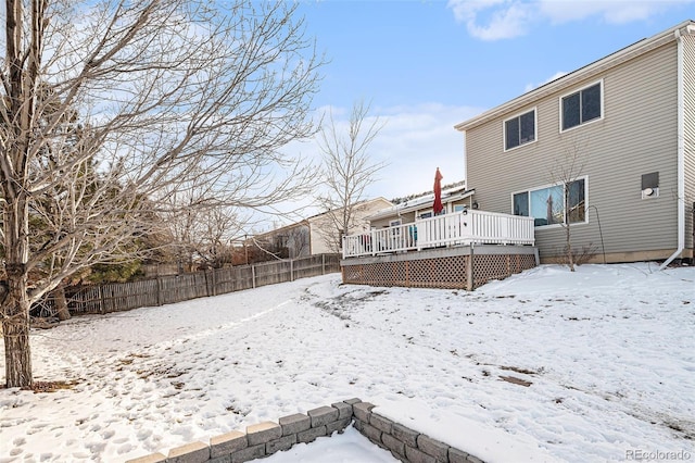 snowy yard with a deck