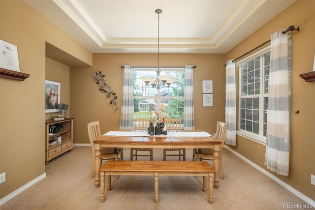 2105 Baguette Dr, Castle Rock, CO 80108 - dining room with a chandelier, a raised ceiling, healthy amount of natural light, and light carpet