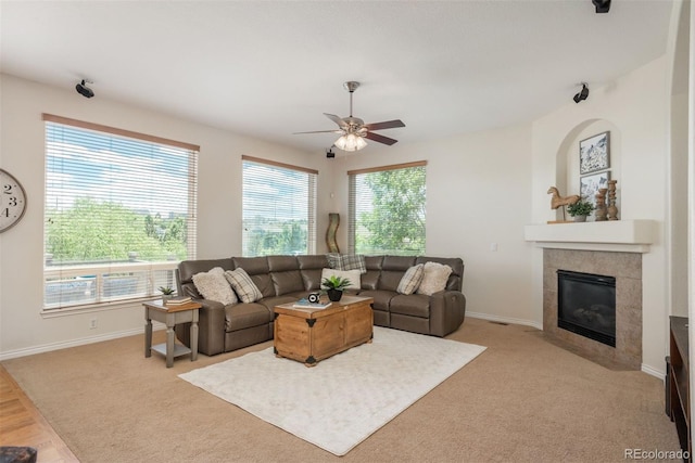 2105 Baguette Dr, Castle Rock, CO 80108 - living area featuring ceiling fan, a tiled fireplace, and light colored carpet