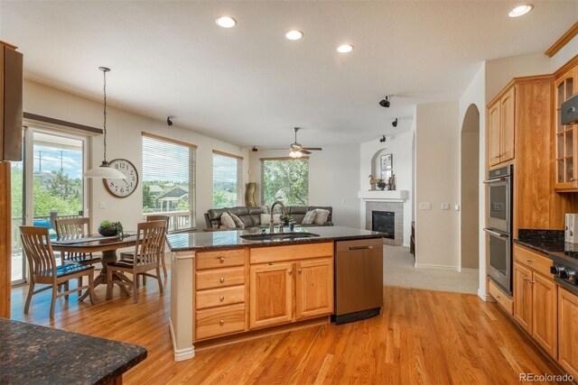 2105 Baguette Dr, Castle Rock, CO 80108 - kitchen featuring appliances with stainless steel finishes, light wood-style floors, open floor plan, recessed lighting, and a ceiling fan