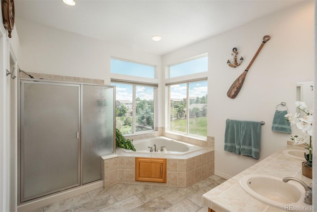 2105 Baguette Dr, Castle Rock, CO 80108 - full bathroom with plenty of natural light, a garden tub, double vanity, a shower stall, and recessed lighting