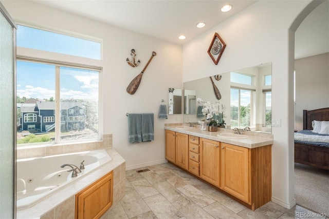 2105 Baguette Dr, Castle Rock, CO 80108 - bathroom featuring double vanity, ensuite bath, a whirlpool tub, a high ceiling, and recessed lighting