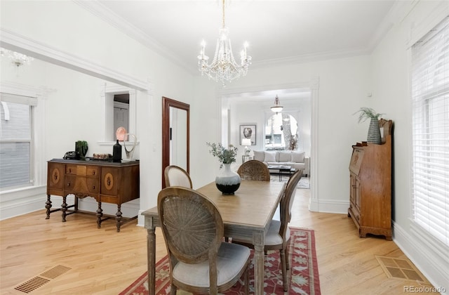 3147 Vallejo St, Denver, CO 80211 - dining room with a chandelier, light wood-type flooring, plenty of natural light, and crown molding