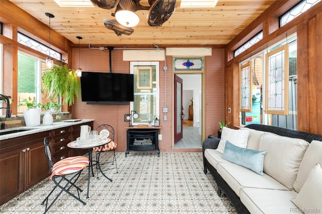 3147 Vallejo St, Denver, CO 80211 - living room featuring healthy amount of natural light, wood ceiling, a skylight, brick wall, and wooden walls