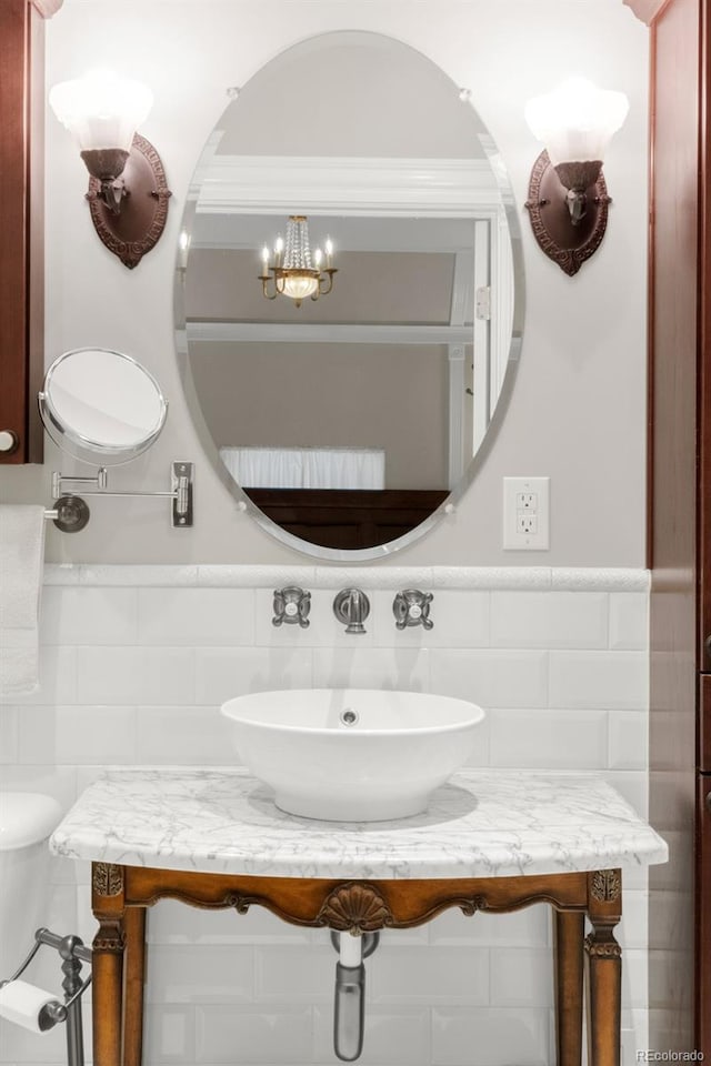 3147 Vallejo St, Denver, CO 80211 - half bathroom featuring tile walls, vanity, a chandelier, a wainscoted wall, and toilet