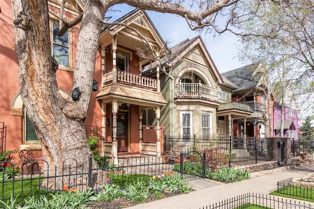 3147 Vallejo St, Denver, CO 80211 - victorian home with a fenced front yard, a balcony, and roof with shingles