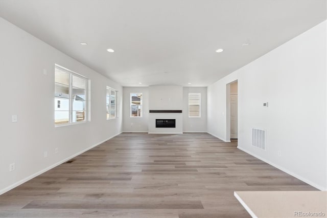 unfurnished living room featuring light hardwood / wood-style flooring