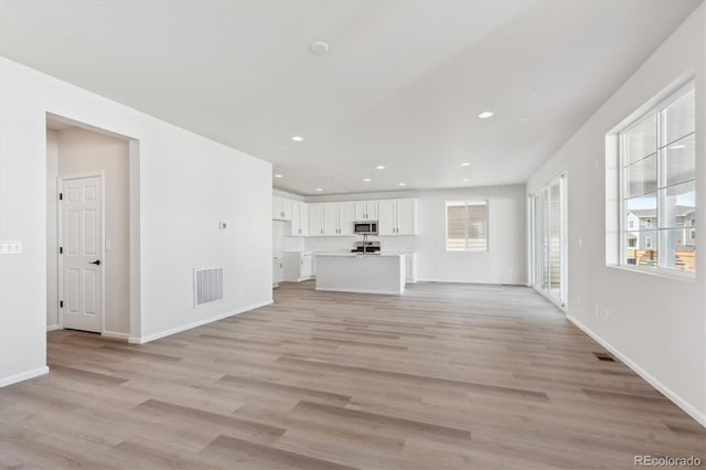 unfurnished living room featuring light wood-type flooring