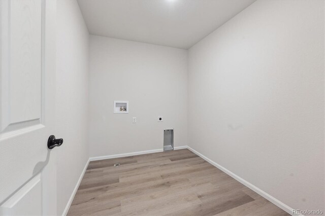 washroom featuring electric dryer hookup, washer hookup, and light hardwood / wood-style floors