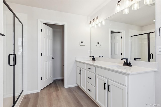 bathroom with vanity, hardwood / wood-style flooring, and walk in shower