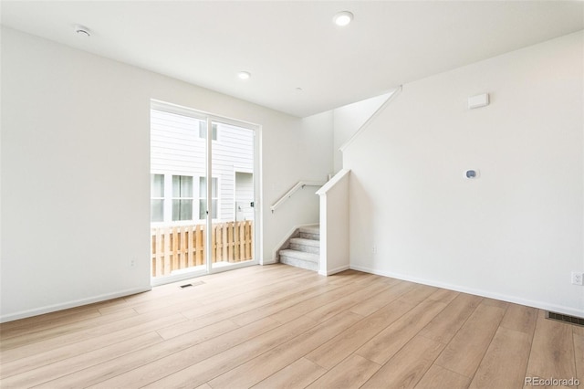 13568 E 111th Ave, Commerce City, CO 80022 - unfurnished living room featuring wood finished floors, stairway, and recessed lighting