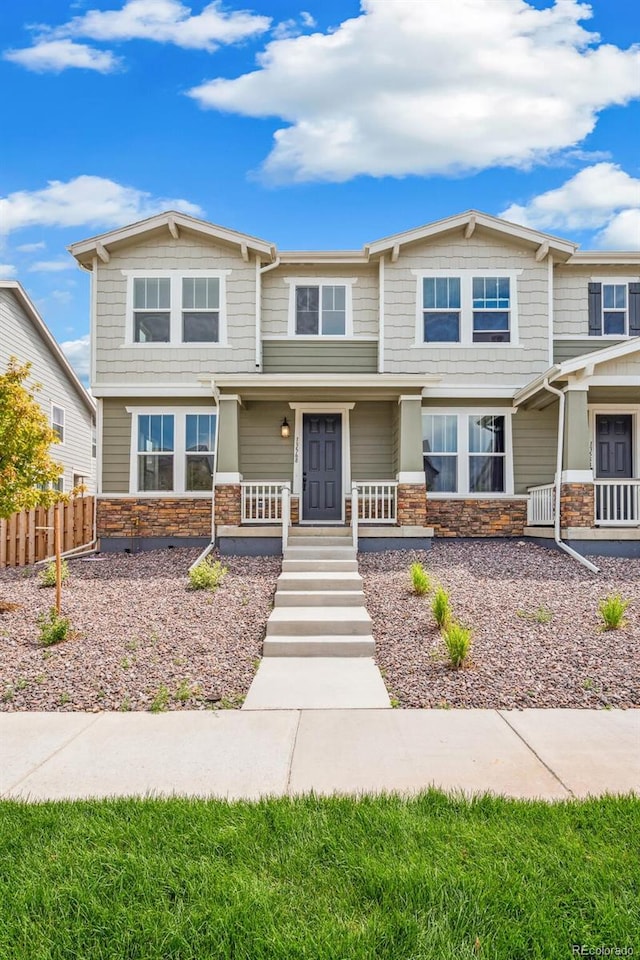 13568 E 111th Ave, Commerce City, CO 80022 - craftsman-style home featuring stone siding and a porch