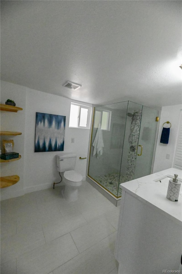 bathroom with toilet, a stall shower, a textured ceiling, visible vents, and tile patterned flooring