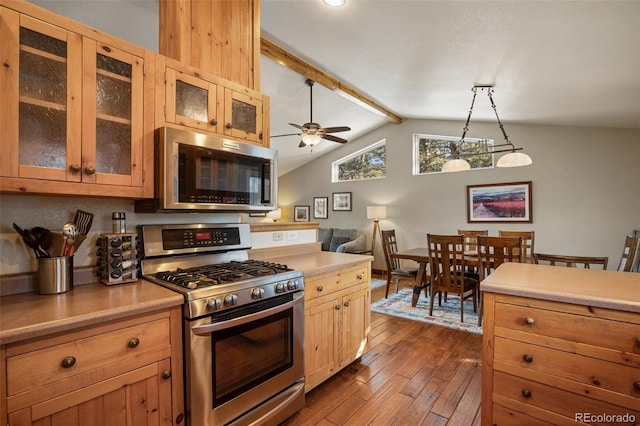 517 Crystal Peak Rd, Florissant, CO 80816 - kitchen featuring stainless steel appliances, dark wood-style floors, light countertops, ceiling fan, and glass insert cabinets