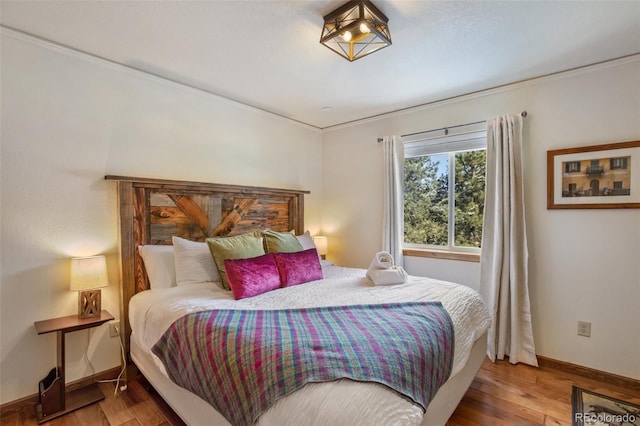 517 Crystal Peak Rd, Florissant, CO 80816 - bedroom featuring wood finished floors, baseboards, and ornamental molding