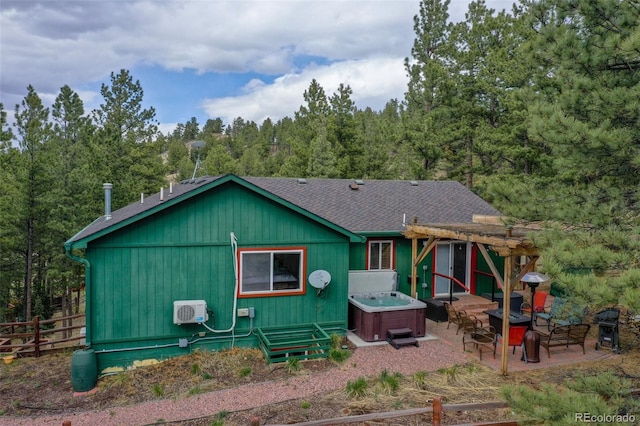517 Crystal Peak Rd, Florissant, CO 80816 - view of front of home featuring a hot tub, a patio, a pergola, roof with shingles, and a forest view