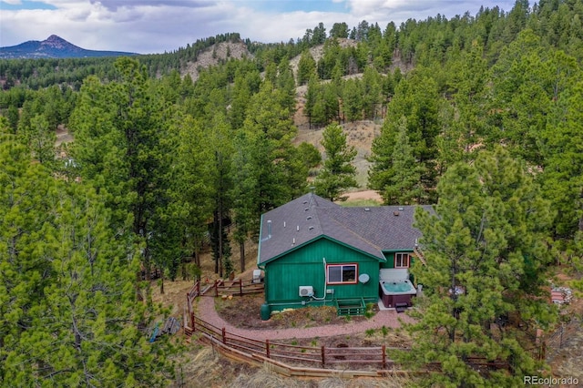 517 Crystal Peak Rd, Florissant, CO 80816 - aerial view of property and surrounding area with a heavily wooded area and a mountainous background