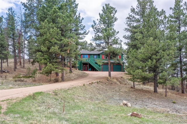 517 Crystal Peak Rd, Florissant, CO 80816 - view of yard with dirt driveway, an attached garage, and stairway