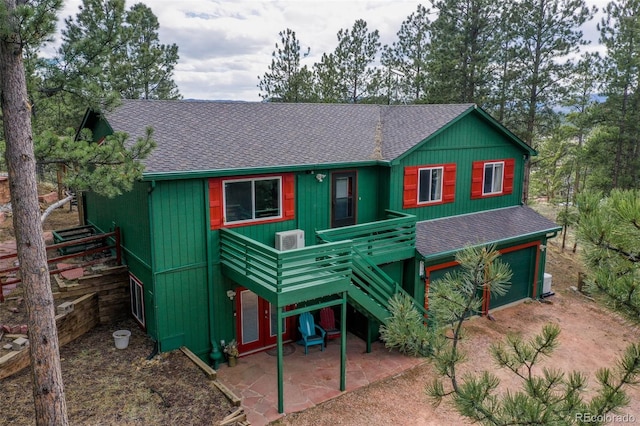 517 Crystal Peak Rd, Florissant, CO 80816 - view of front facade with a shingled roof, a wooden deck, and a patio