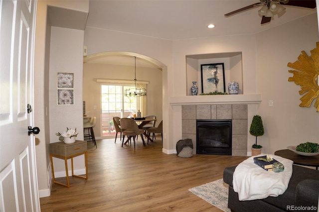 6845 S Webster St Unit E, Littleton, CO 80128 - living room with wood finished floors, ceiling fan, recessed lighting, arched walkways, and a chandelier