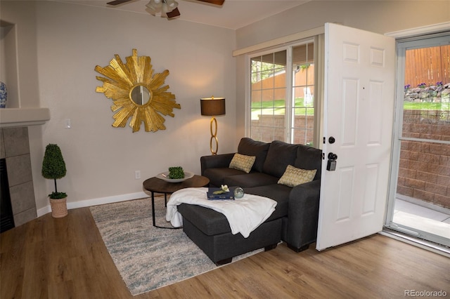 6845 S Webster St Unit E, Littleton, CO 80128 - living area featuring wood finished floors, ceiling fan, and a fireplace