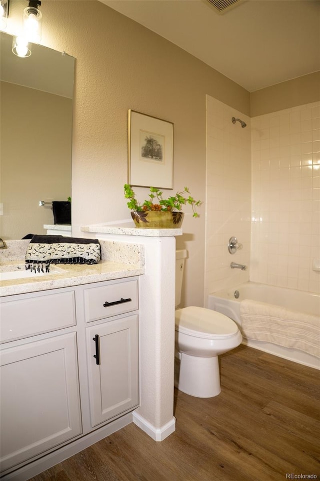 6845 S Webster St Unit E, Littleton, CO 80128 - full bathroom with wood finished floors, vanity, and tub / shower combination