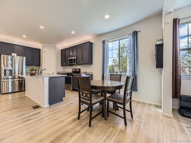 917 White Leaf Cir, Castle Rock, CO 80108 - dining area featuring healthy amount of natural light, light wood-style floors, recessed lighting, and baseboards