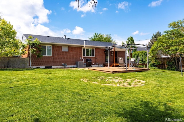 2438 W 24th Street Rd, Greeley, CO 80634 - back of property featuring a wooden deck, brick siding, central AC, and a pergola