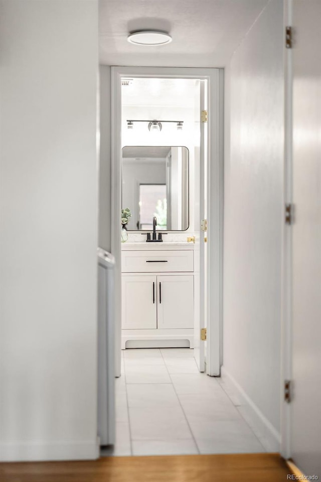 6463 S Vance St, Littleton, CO 80123 - corridor featuring baseboards and light tile patterned flooring