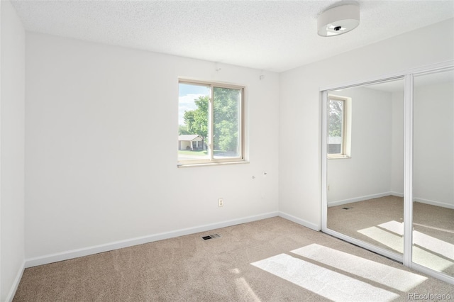 6463 S Vance St, Littleton, CO 80123 - unfurnished bedroom with carpet, a textured ceiling, and a closet