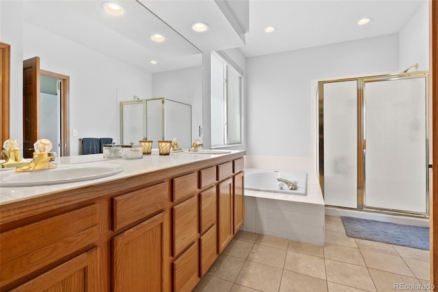 full bath with a garden tub, a sink, a shower stall, tile patterned floors, and double vanity