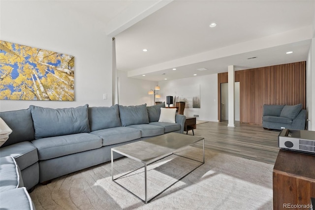 living area with visible vents, wood finished floors, and recessed lighting