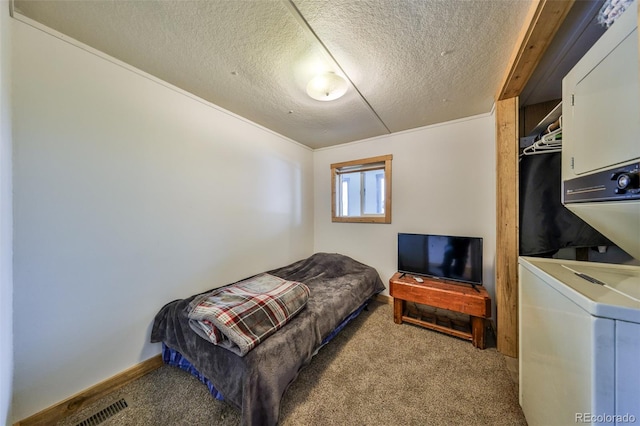 bedroom with stacked washer / dryer, light carpet, and a textured ceiling