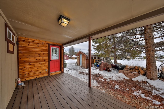 snow covered deck with a storage unit