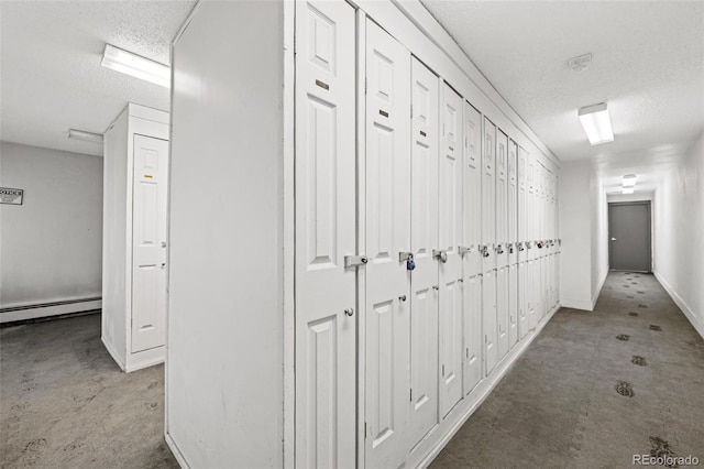107 N Harris St Unit 102, Breckenridge, CO 80424 - hallway featuring a textured ceiling, baseboard heating, and baseboards
