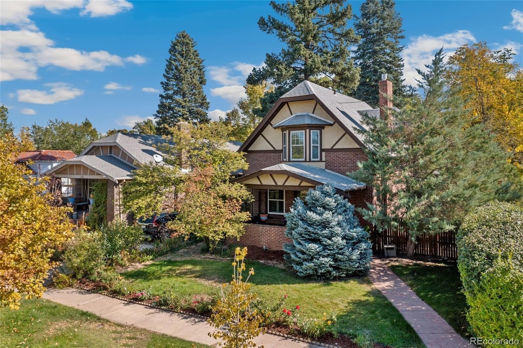 english style home featuring a front lawn